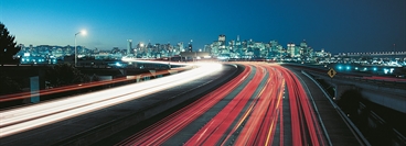 Highway in the evening with long time image exposure. View of San Francisco in the background.