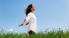 Woman standing in open field breathing. Grass and sky. Only to be used with ENTONOX/LIVOPAN campaign!